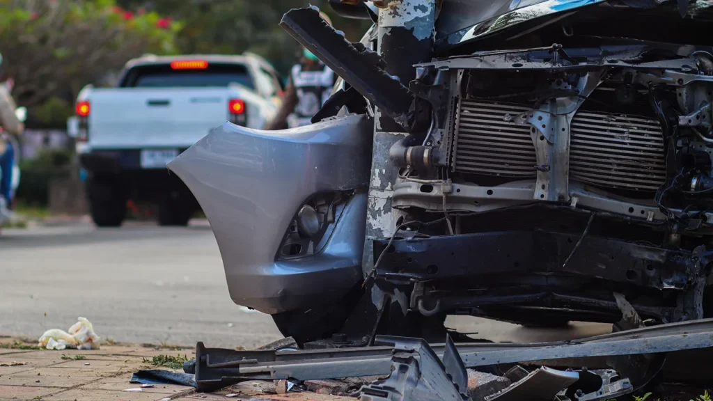 Severely damaged car front bumper after a crash.