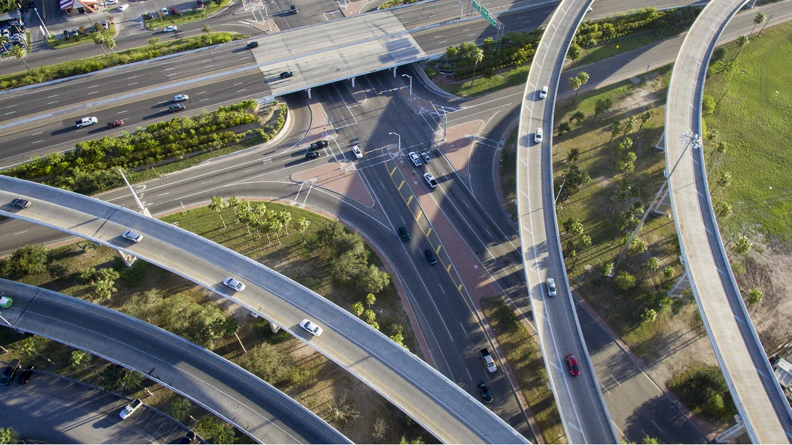 Aerial view of a complex highway interchange with curving overpasses and ramps.