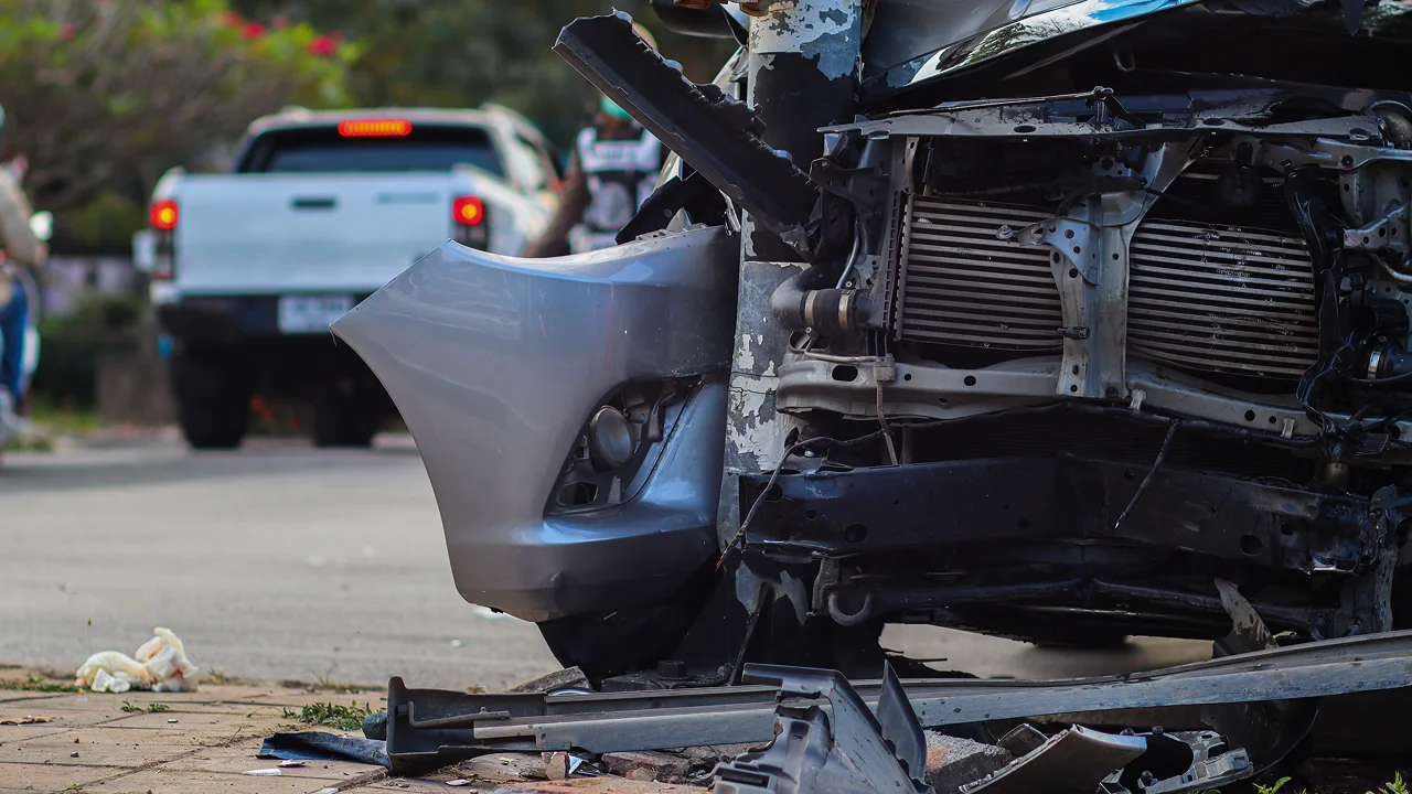 Close-up view of heavy front-end damage to a car after an accident.