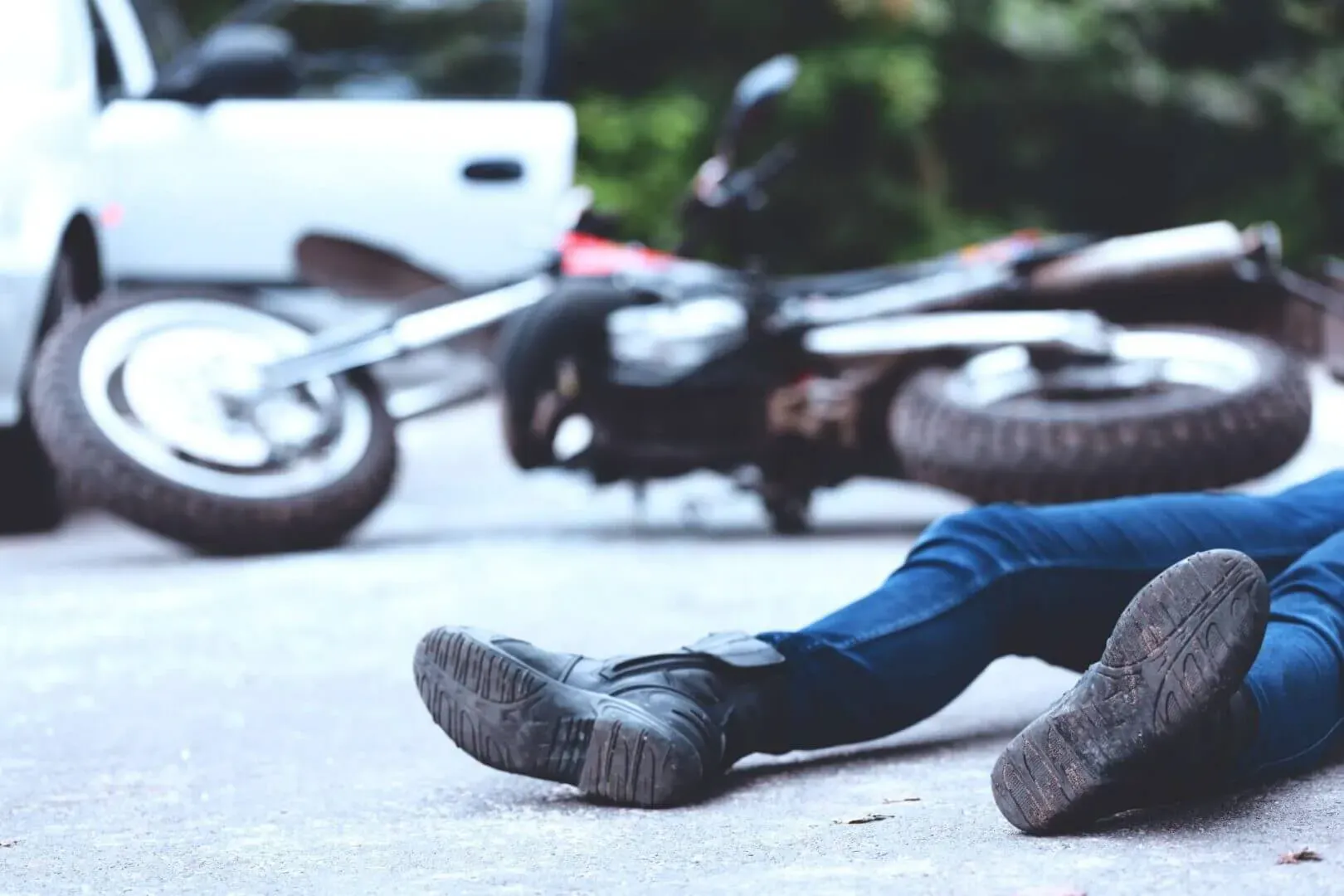 A close-up view of a person lying on the asphalt after an accident in image.
